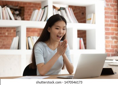 Excited Young Asian Female Student Sitting At Desk In Library, Looking At Computer Monitor, Received Mail With Good News, University Admission Or Successful Test Passing With High Score Notification.