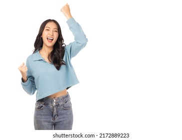 Excited young asian woman with raised hands celebrating success Portrait cheerful positive asian female with raised hands and fists open mouth Girl get happy, enjoy life isolated on white copy space