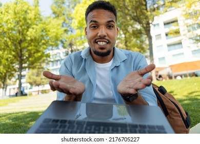 Excited Young Black Guy Talking To Family Or Friend On Laptop, Gesturing At Webcamera, Sitting Outdoors. Positive Man Chatting On Internet, Webcam View Pov