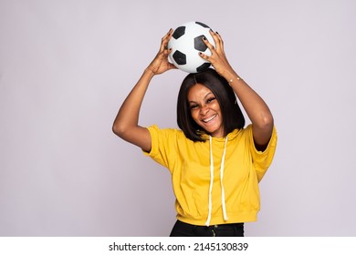 Excited Young Black Lady Holding A Soccer Ball