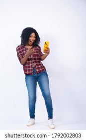 Excited Young Black Woman Feeling Surprised And Happy While Using Her Phone