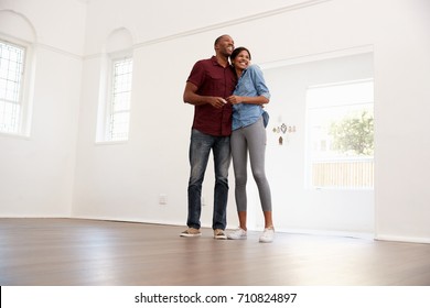 Excited Young Couple Moving Into New Home Together