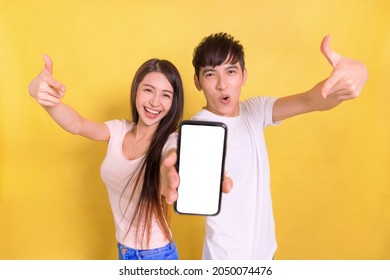 Excited Young  Couple Pointing At Blank  Smartphone Screen