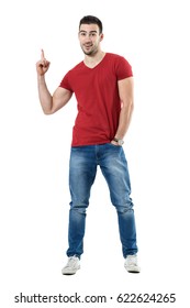 Excited Young Happy Casual Man Pointing Finger Up Showing Blank Space. Full Body Length Portrait Isolated Over White Studio Background.