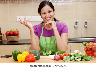 Excited Young Indian Woman In Kitchen