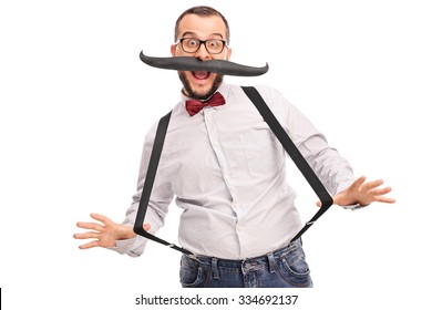 Excited Young Male Hipster With Fake Mustache And Black Suspenders Isolated On White Background