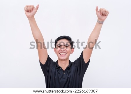An excited young man with outstretched arms, feeling happy and confident. Isolated on a white backdrop.