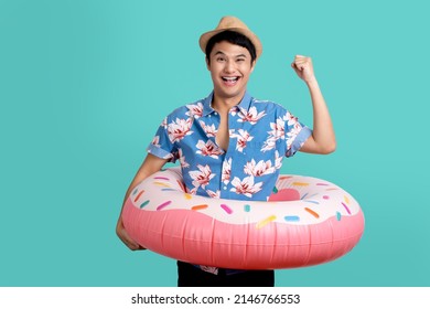 Excited young man wearing a summer shirt and hat hold inflatable ring isolated on blue background studio portrait. Summer vacation sea rest sun tan concept - Powered by Shutterstock