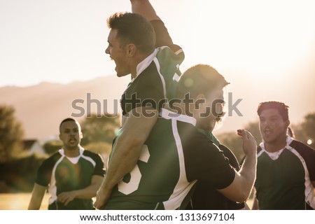 Excited young rugby players celebrating a win at the sports field. Rugby team enjoying after the victory. ストックフォト © 