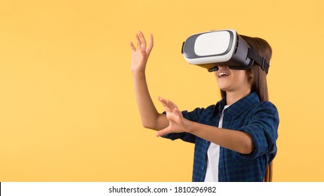 Excited Young Schoolgirl Using VR Headset and Experiencing Virtual Reality, Patel Yellow Wall, Copy Space, Banner - Powered by Shutterstock