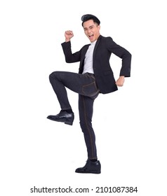 Excited young successful business man jumping and dancing