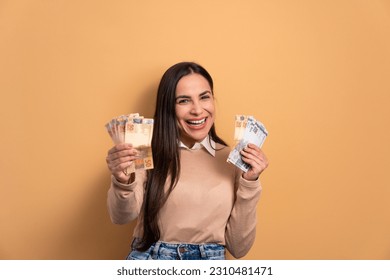 excited young woman with brazil banknotes currency in beige colors. economy, payment, successful concept. - Powered by Shutterstock