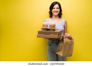 Excited Young Woman Going Out To Buy Takeout Food. Beautiful Woman Holding Pizza Boxes And Coffee To-go