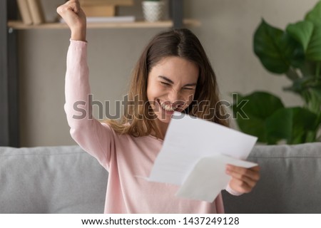 Excited young woman hold paper letter feel euphoric receiving job promotion or tax refund from bank, happy girl reading paperwork document smiling of good pleasant news, getting student scholarship