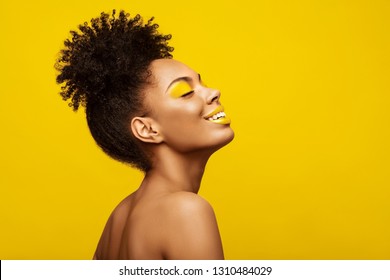 Excitement African American Fashion Model Profile Portrait . Satisfied Brunette Young Woman With Afro Hair Style,creative Yellow Make Up, Lips And Eyeshadows On Colorful Background