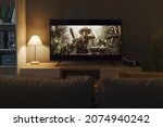 Exciting adventure movie on a widescreen TV and living room interior