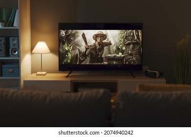 Exciting adventure movie on a widescreen TV and living room interior - Shutterstock ID 2074940242