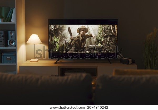Exciting adventure movie on a widescreen TV and\
living room interior