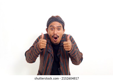 Exciting asian man standing and showing thumbs up with both hand. Isolated on white background