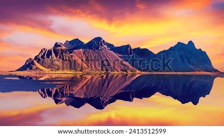 Exciting beautiful landscape with most breathtaking mountains Vestrahorn on the Stokksnes peninsula in the mirror of the lake at sunset. Exotic countries. (Meditation, antistress - concept).