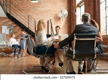 Exciting boardroom meeting with business people in trendy office space