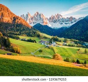 Exciting evening view of Santa Magdalena village in front of the Geisler or Odle Dolomites Group. Colorful autumn sunset in Dolomite Alps, Italy, Europe. Beauty of countryside concept background.