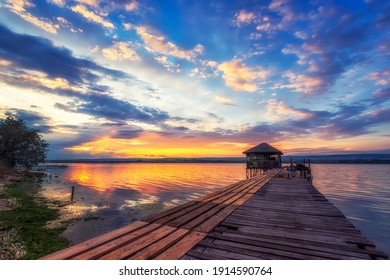 Exciting long exposure landscape on a lake with a wooden pier and small house in the end. - Powered by Shutterstock