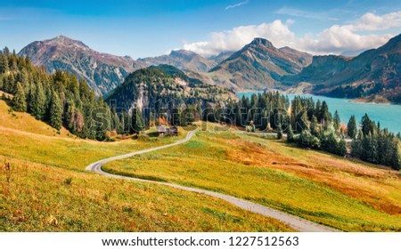 Exciting morning view of Roselend lake/Lac de Roselend. Fantastic autumn scene of Auvergne-Rhone-Alpes, France, Europe. Beauty of nature concept background. Amazing world of Alpine Mountains.
