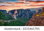 Exciting summer view of famous Eastern Orthodox monasteries listed as a World Heritage site, built on top of rock pillars. Stunning evening scene of Kalabaka, Greece. Traveling concept background.
