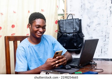 Exciting Teenage Young Black Boy Using Mobile Phone At Home