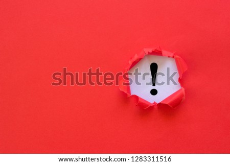 Exclamation mark concept. Torn red paper with exclamation mark on white background.