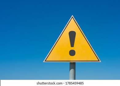 Exclamation mark on a yellow road sign. Against the blue sky Warning, danger, attention - Shutterstock ID 1785459485