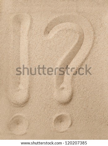 Exclamation point and question mark writing on the sand