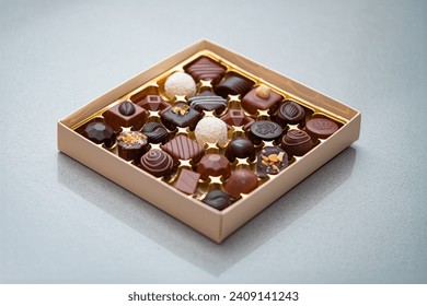 Exclusive Assortment of Gourmet Chocolates in a Luxury Gift Box - Perfect for Sweet Indulgence and Special Occasions on a granite surface - Powered by Shutterstock