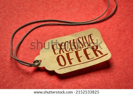 exclusive offer-  sign a paper price tag against textured red paper, shopping and marketing concept