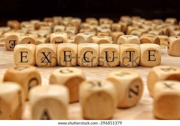 execute-word-written-on-wood-block-stock-photo-edit-now-296851379