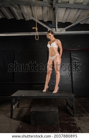 Execution by hanging. Pretty blonde in the handcuffs going to be hanged.