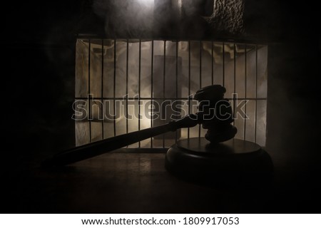 Execution with Lethal injection concept. Death penalty lethal injection table miniature inside old prison. Old prison bars cell lock. Creative artwork decoration. Old grunge prison interior.