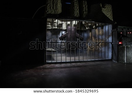 Execution with Lethal injection concept. Death penalty lethal injection table miniature inside old prison. Old prison bars cell lock. Creative artwork decoration. Old grunge prison interior.