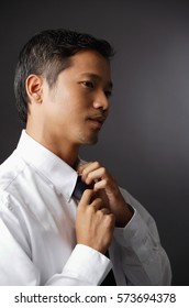 Executive adjusting tie