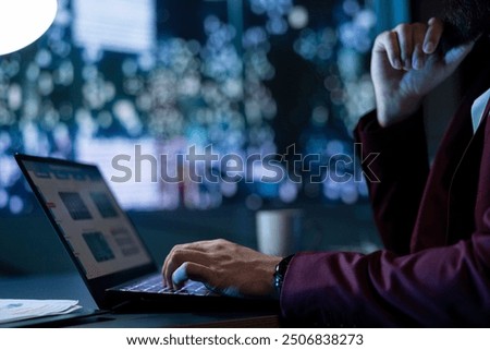 Executive chief structuring funding development plan at night, enjoying skyscraper view in his office. Wealthy businessman creating financial reports on laptop, studying laws before investing.