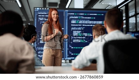 Executive Coder Gives Presentation To Diverse Team In Boardroom