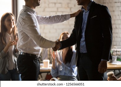 Executive director manager handshaking worker promoting motivating employee shake hands promise rewarding thanking for good work, feedback respect, rewarding recognition concept, team support applaud - Shutterstock ID 1256566051