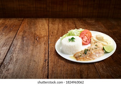 Executive Dish With Fried Hake Filet With Rice, Salad And Mashed Potatoes, On Wooden Background