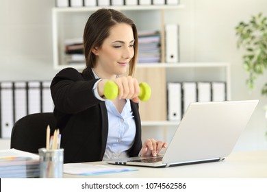 Executive exercising doing weights and working at office - Powered by Shutterstock