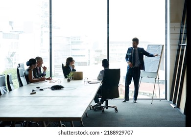Executive having a presentation in a boardroom at a modern office. Businesspeople listening to a serious business leader presenting a vision, thinking and mission for a project at the workplace. - Shutterstock ID 2188929707