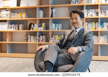Executive man sitting in lobby.