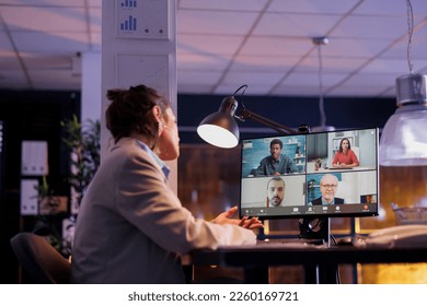Executive manager explaining financial strategy to remote team during online videocall meeting conference. Young entrepreneur working late at night at investment plan to increase company profit