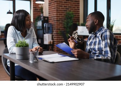 Executive Manager Having Candidate CV Resume While Discussing About Job Description And Salary Offer. Job Applicant Sitting At Desk In Office While Listening To Employer Talking About Work Policy