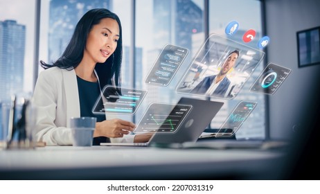 Executive Officer Talking on a Video Call with Business Partner. Laptop Computer with Augmented Reality Conference Stream and Essential Financial and Business Data Pop Out From Manager's Laptop. - Powered by Shutterstock